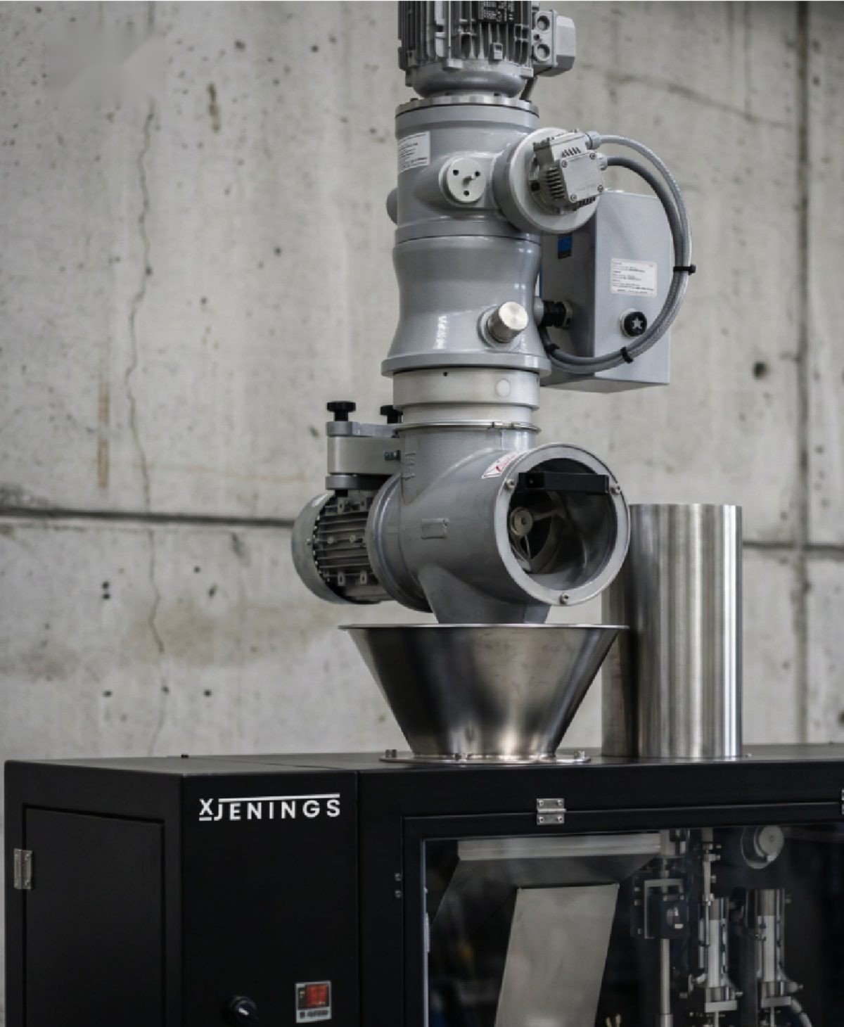 Close-up of the dosing and filling head of the pouch machine