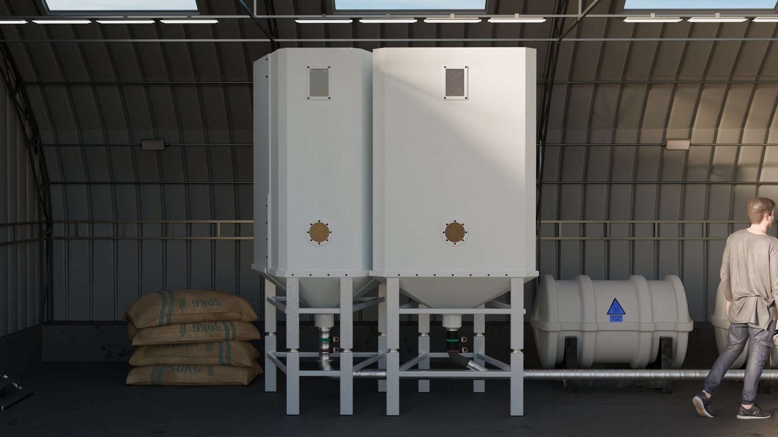Two XJENINGS silos in a linear battery configuration inside a warehouse, with a person for scale